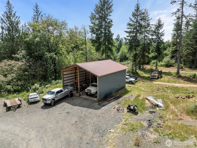 253 Kruger Rd Unit B, Onalaska, WA 98570 - view of parking / parking lot featuring dirt driveway, a detached carport, and a forest view
