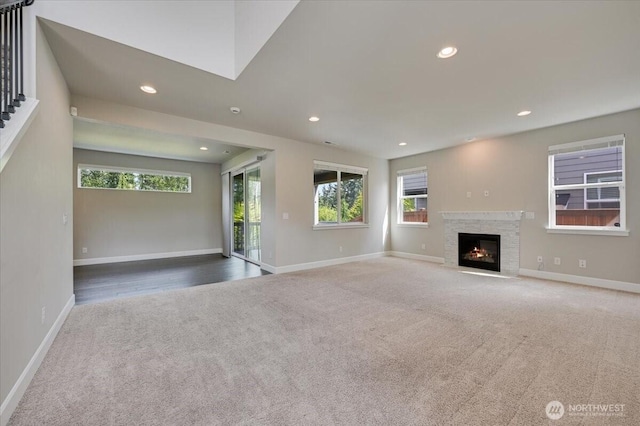 16311 5th Dr SE, Bothell, WA 98012 - unfurnished living room with carpet, recessed lighting, and a fireplace with flush hearth