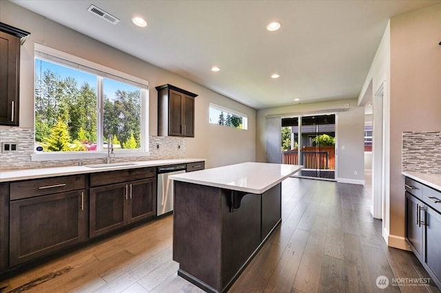 16311 5th Dr SE, Bothell, WA 98012 - kitchen featuring stainless steel dishwasher, light countertops, decorative backsplash, dark brown cabinetry, and recessed lighting