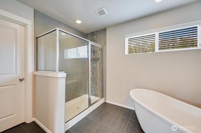 16311 5th Dr SE, Bothell, WA 98012 - bathroom with a freestanding tub, healthy amount of natural light, tile patterned floors, a shower stall, and recessed lighting