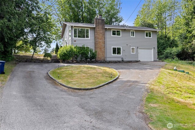 824 SW 301st Pl, Federal Way, WA 98023 - view of front facade with asphalt driveway, a chimney, a garage, and a front lawn