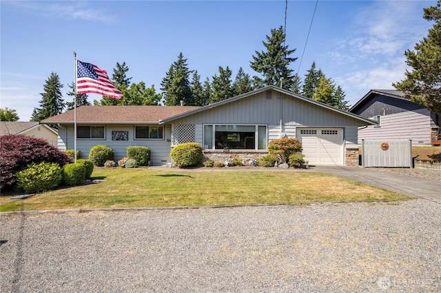 1023 E Maple St, Kent, WA 98030 - ranch-style home with an attached garage, driveway, a front lawn, and stone siding