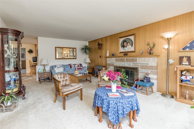1023 E Maple St, Kent, WA 98030 - living room featuring carpet, a stone fireplace, and wood walls