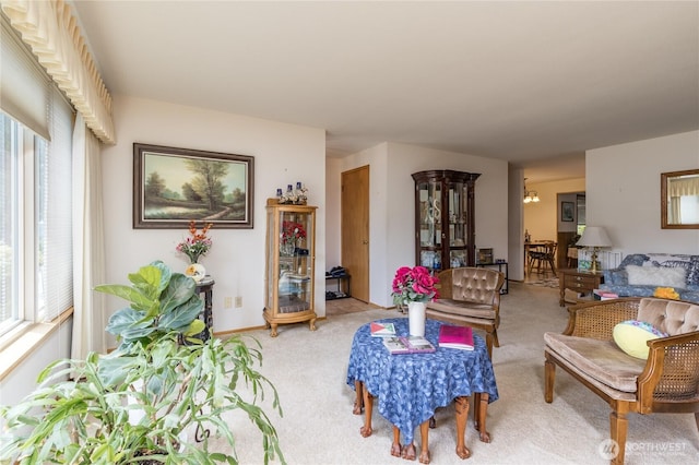 1023 E Maple St, Kent, WA 98030 - living area with light carpet, healthy amount of natural light, and a chandelier