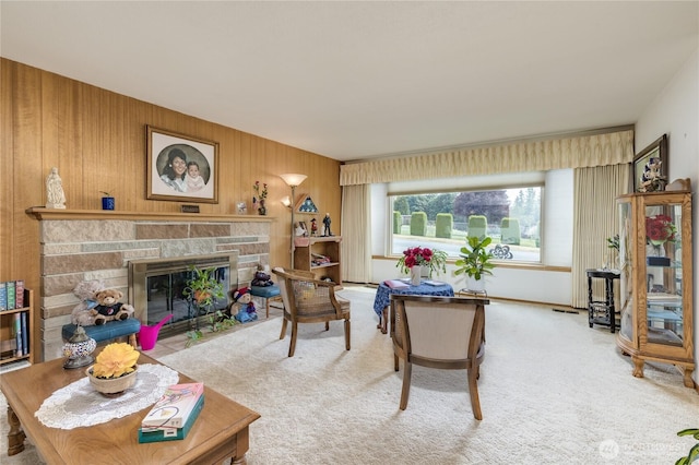1023 E Maple St, Kent, WA 98030 - living room featuring a stone fireplace, carpet, and wood walls