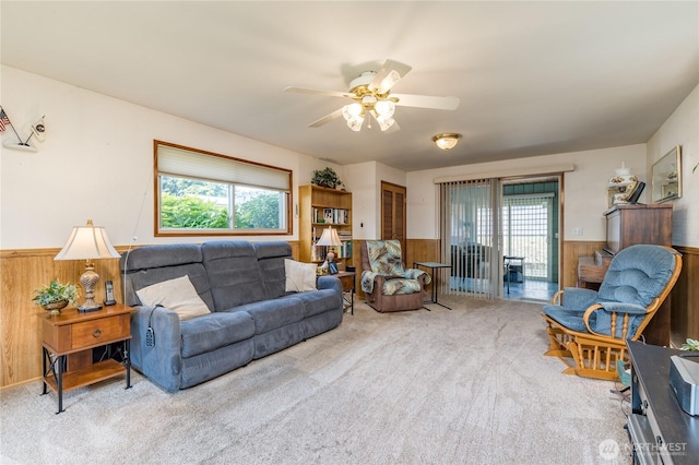1023 E Maple St, Kent, WA 98030 - living area with a wainscoted wall, wooden walls, healthy amount of natural light, carpet flooring, and ceiling fan