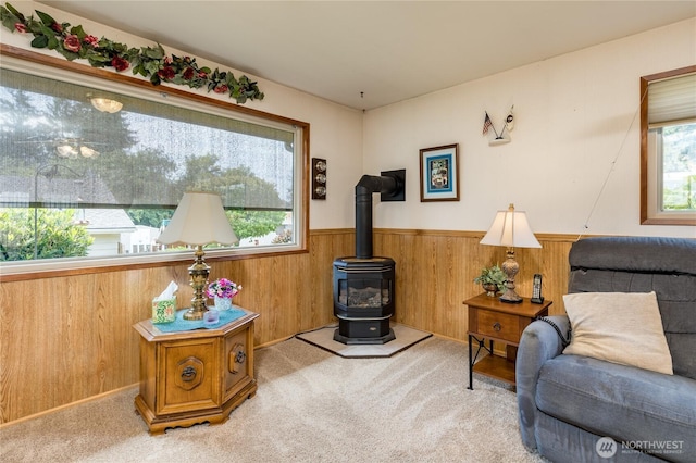 1023 E Maple St, Kent, WA 98030 - living room with a wainscoted wall, carpet flooring, a wood stove, and wooden walls