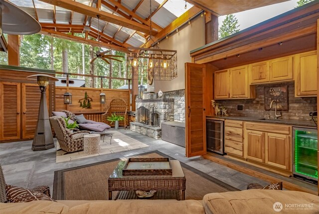 1546 Reservation Rd SE Unit 213, Olympia, WA 98513 - living area featuring beverage cooler, high vaulted ceiling, a ceiling fan, and a stone fireplace