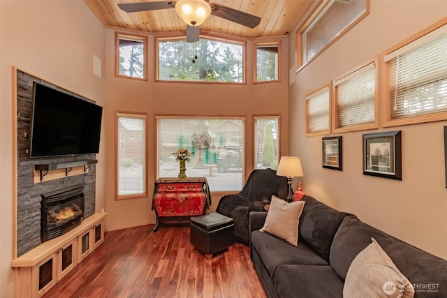 1546 Reservation Rd SE Unit 213, Olympia, WA 98513 - living area featuring wood ceiling, plenty of natural light, a glass covered fireplace, hardwood / wood-style floors, and ceiling fan