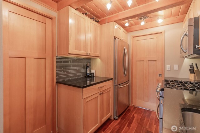 1546 Reservation Rd SE Unit 213, Olympia, WA 98513 - kitchen with appliances with stainless steel finishes, a wooden ceiling with exposed beams, tasteful backsplash, dark wood-style flooring, and dark stone countertops