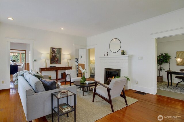2433 E Valley St, Seattle, WA 98112 - living room featuring wood finished floors, a glass covered fireplace, and recessed lighting