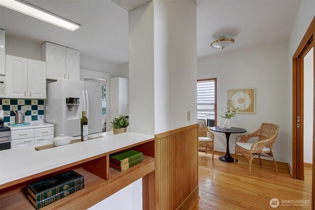 2433 E Valley St, Seattle, WA 98112 - kitchen featuring white appliances, healthy amount of natural light, white cabinetry, and light countertops