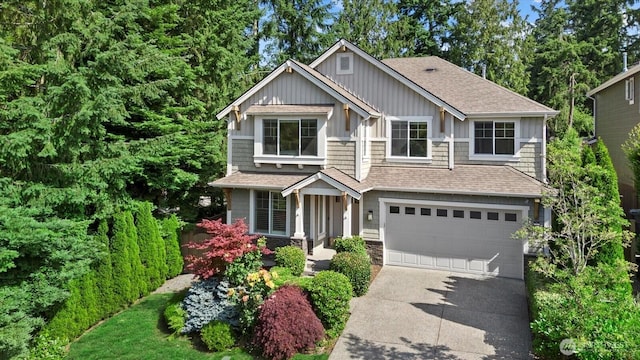 8132 NE 117th Pl, Kirkland, WA 98034 - craftsman house featuring driveway, a garage, roof with shingles, stone siding, and board and batten siding
