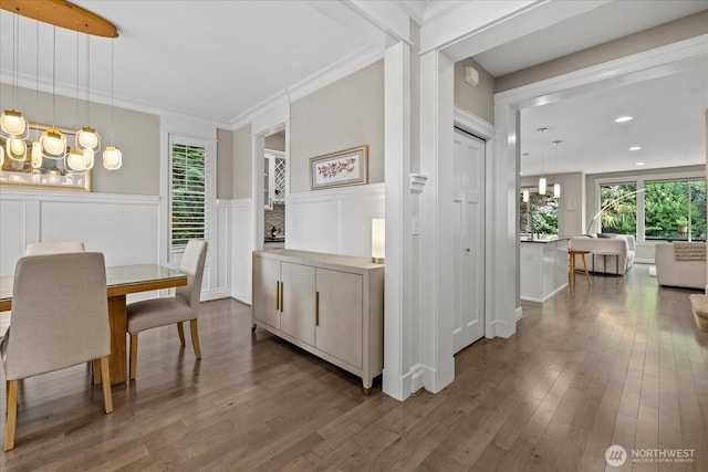 8132 NE 117th Pl, Kirkland, WA 98034 - dining room featuring healthy amount of natural light, a chandelier, dark wood-style floors, a decorative wall, and wainscoting