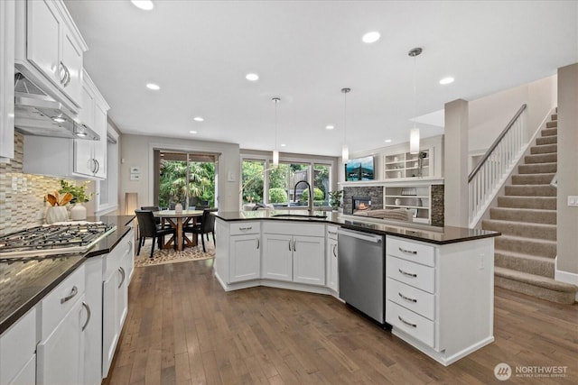 8132 NE 117th Pl, Kirkland, WA 98034 - kitchen featuring appliances with stainless steel finishes, a fireplace, recessed lighting, decorative backsplash, and white cabinets