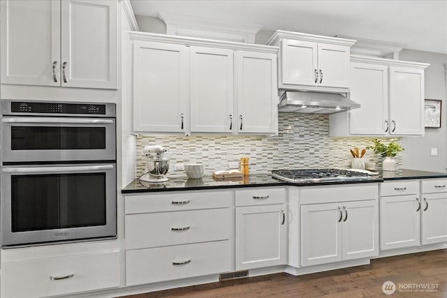 8132 NE 117th Pl, Kirkland, WA 98034 - kitchen with appliances with stainless steel finishes, exhaust hood, dark countertops, and white cabinets