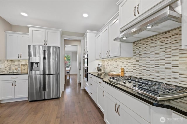 8132 NE 117th Pl, Kirkland, WA 98034 - kitchen featuring appliances with stainless steel finishes, under cabinet range hood, dark countertops, white cabinetry, and backsplash