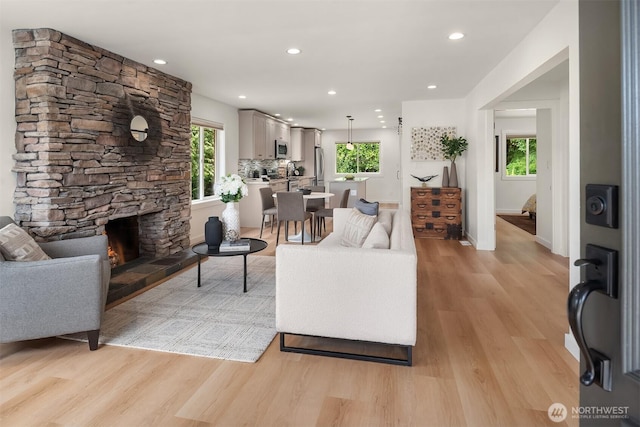 4886 24th Ave S, Seattle, WA 98108 - living area featuring light wood-style flooring, recessed lighting, and a stone fireplace