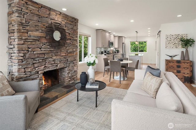 4886 24th Ave S, Seattle, WA 98108 - living room with light wood-style floors, recessed lighting, and a fireplace