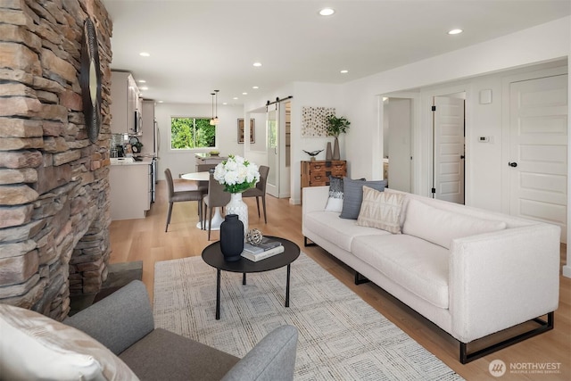 4886 24th Ave S, Seattle, WA 98108 - living room with a barn door, light wood-style flooring, and recessed lighting