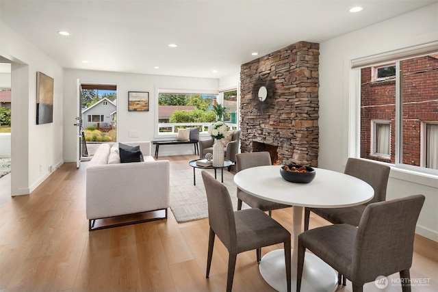 4886 24th Ave S, Seattle, WA 98108 - dining room featuring light wood-style flooring, recessed lighting, and a stone fireplace