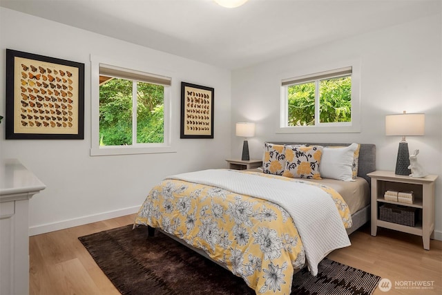 4886 24th Ave S, Seattle, WA 98108 - bedroom featuring multiple windows and light wood-type flooring