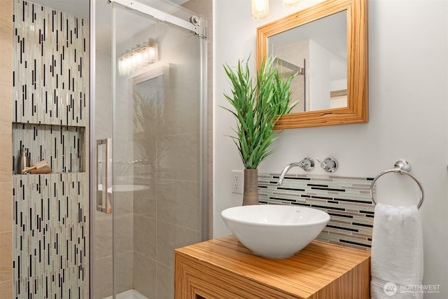 4886 24th Ave S, Seattle, WA 98108 - bathroom featuring a shower stall, vanity, and tasteful backsplash