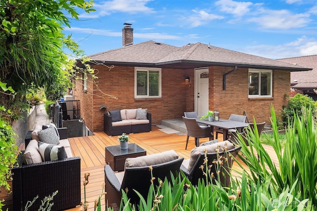4886 24th Ave S, Seattle, WA 98108 - back of house with outdoor lounge area, a chimney, brick siding, and a deck