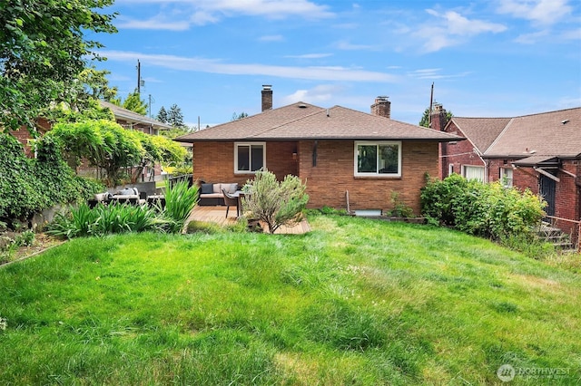 4886 24th Ave S, Seattle, WA 98108 - rear view of property featuring an outdoor living space, brick siding, a lawn, and a chimney