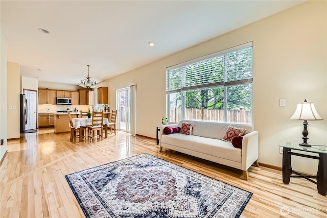 3205 179th Pl SE, Bothell, WA 98012 - living area featuring light wood-style floors and a chandelier