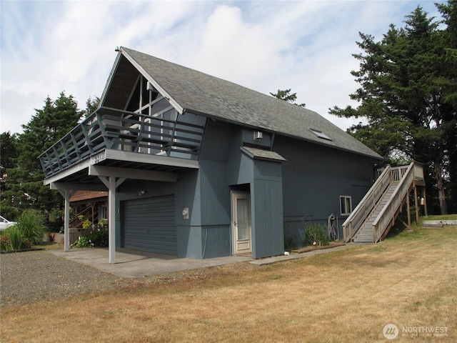 33610 J Pl, Ocean Park, WA 98640 - view of side of property featuring an attached garage, a yard, stairs, gravel driveway, and a balcony