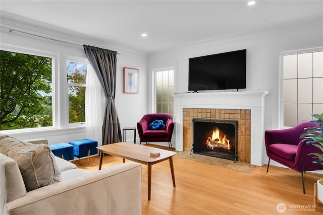 1916 11th Ave W, Seattle, WA 98119 - living area with a tile fireplace, light wood-style flooring, plenty of natural light, crown molding, and recessed lighting