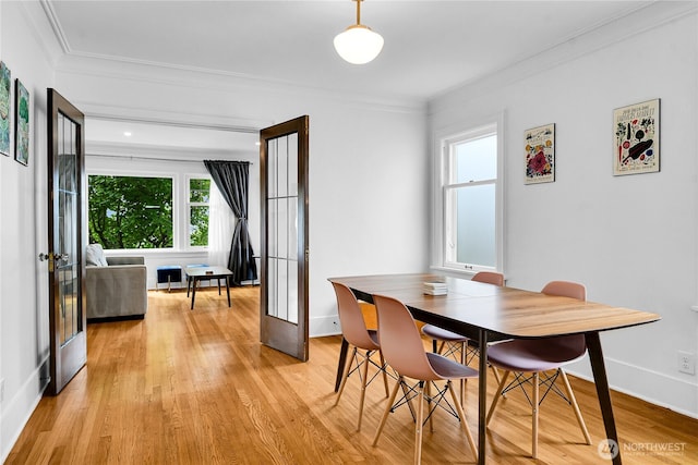 1916 11th Ave W, Seattle, WA 98119 - dining room featuring ornamental molding, plenty of natural light, light wood-style floors, and french doors