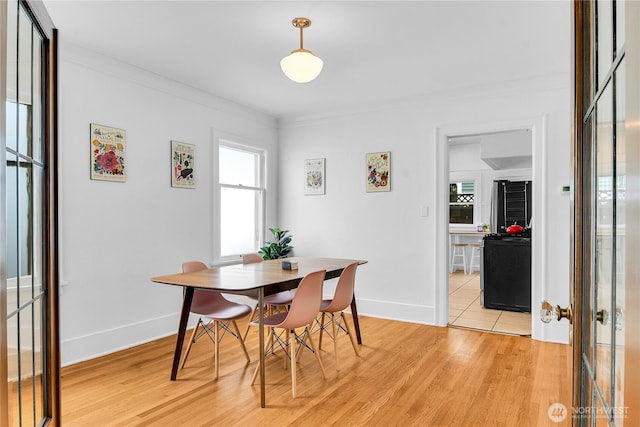 1916 11th Ave W, Seattle, WA 98119 - dining area with light wood-style flooring and crown molding