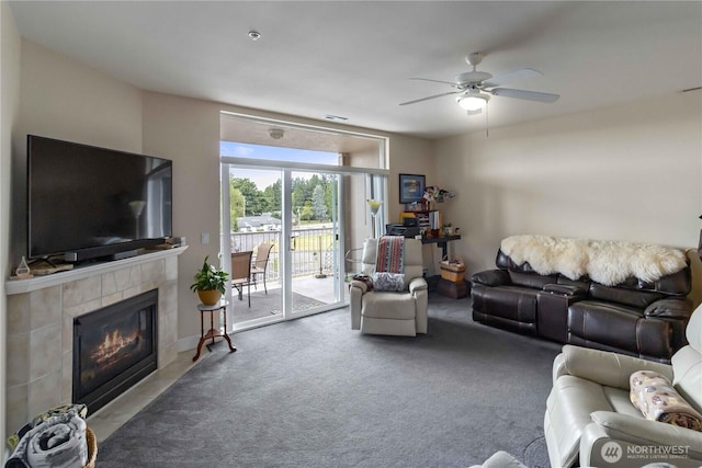 1548 River Rd Unit 301, Longview, WA 98632 - living area featuring ceiling fan, a tiled fireplace, and carpet