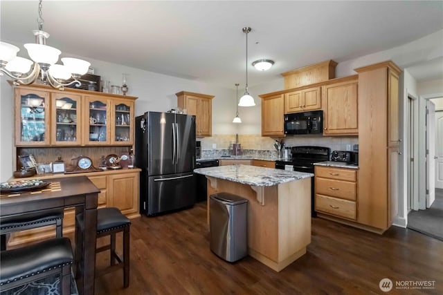 1548 River Rd Unit 301, Longview, WA 98632 - kitchen with black appliances, dark wood-type flooring, a chandelier, and decorative backsplash