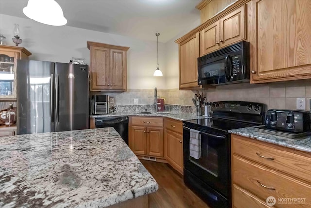 1548 River Rd Unit 301, Longview, WA 98632 - kitchen featuring black appliances, light stone countertops, backsplash, and dark wood-style flooring