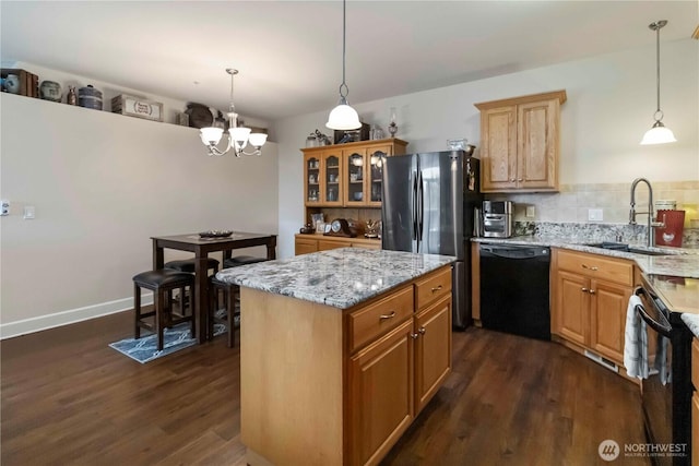 1548 River Rd Unit 301, Longview, WA 98632 - kitchen featuring black dishwasher, dark wood-style flooring, freestanding refrigerator, light stone countertops, and a chandelier