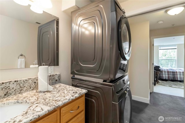 1548 River Rd Unit 301, Longview, WA 98632 - laundry area featuring estacked washer and dryer and dark carpet