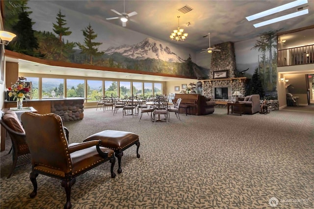 1548 River Rd Unit 301, Longview, WA 98632 - living area with ceiling fan, carpet, a high ceiling, a stone fireplace, and a skylight