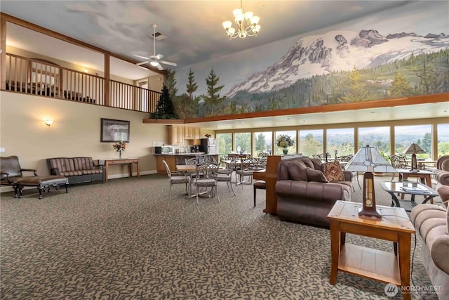 1548 River Rd Unit 301, Longview, WA 98632 - carpeted living room featuring a towering ceiling, a ceiling fan, and a chandelier