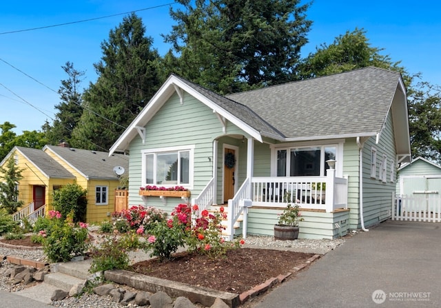 4106 SW Kenyon St, Seattle, WA 98136 - bungalow-style home with a porch, a shingled roof, an outbuilding, and a detached garage