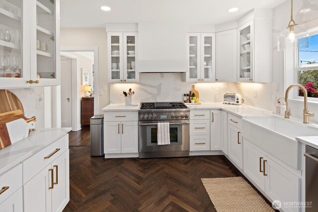 4106 SW Kenyon St, Seattle, WA 98136 - kitchen featuring appliances with stainless steel finishes, recessed lighting, white cabinetry, backsplash, and custom range hood