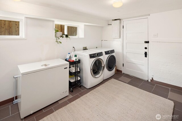 4106 SW Kenyon St, Seattle, WA 98136 - laundry area with separate washer and dryer and dark tile patterned floors