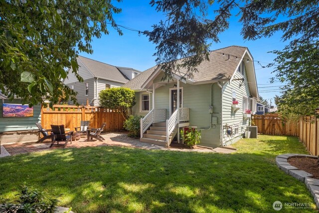 4106 SW Kenyon St, Seattle, WA 98136 - back of property featuring a fenced backyard, roof with shingles, a patio area, and an outdoor fire pit