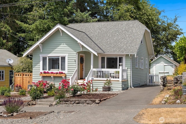 4106 SW Kenyon St, Seattle, WA 98136 - bungalow-style house with covered porch, a shingled roof, an outdoor structure, and a detached garage