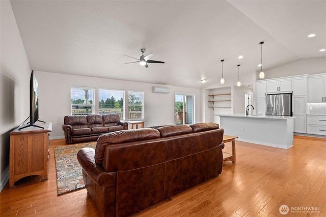 17133 123rd Ct SE, Yelm, WA 98597 - living area with light wood finished floors, ceiling fan, an AC wall unit, and lofted ceiling