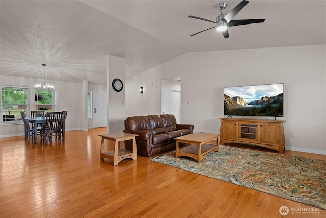 17133 123rd Ct SE, Yelm, WA 98597 - living area with a chandelier, light wood-type flooring, vaulted ceiling, and a ceiling fan