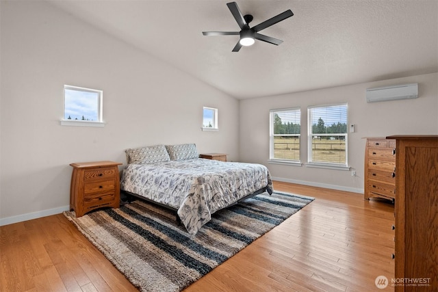 17133 123rd Ct SE, Yelm, WA 98597 - bedroom with wood finished floors, lofted ceiling, a wall mounted AC, and a ceiling fan