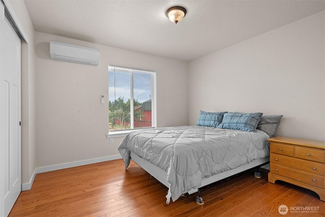 17133 123rd Ct SE, Yelm, WA 98597 - bedroom with a wall mounted air conditioner, hardwood / wood-style flooring, and a closet